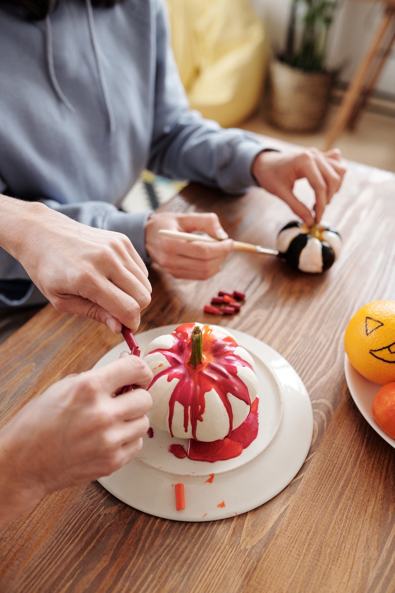 Person Decorating A Halloween Pumpkin